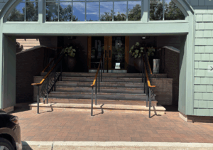 Eight steps up to double door main entrance