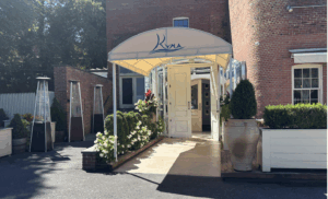 Street-level, single door entrance to Kyma, roslyn