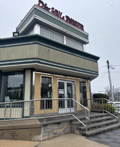 Four steps up to double door entrance of Dix Hills Diner